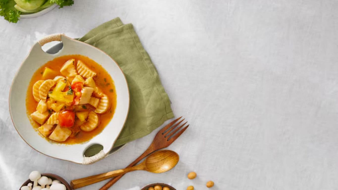 Pasta dish with vegetables on table